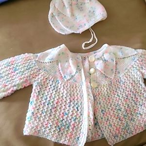 Handmade knit white speckled sweater and bonnet.